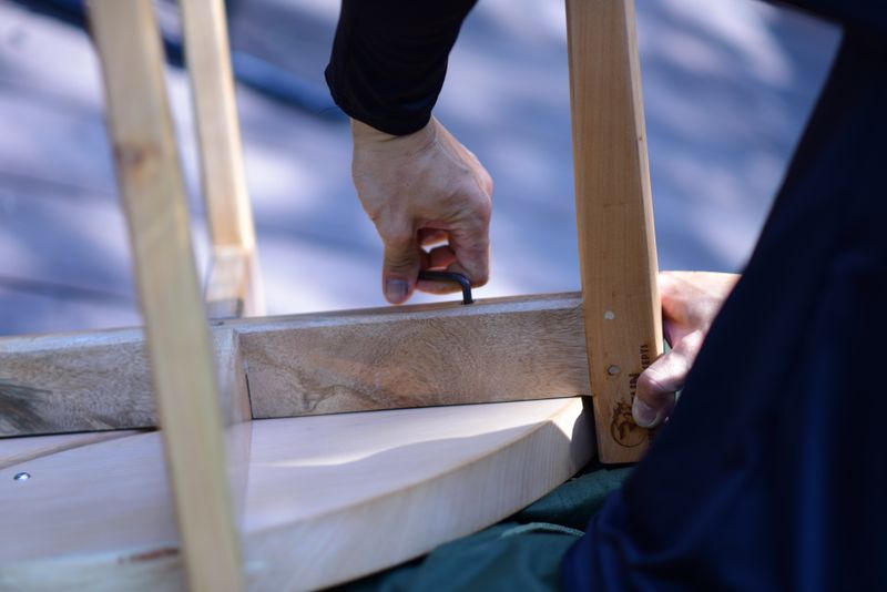 Furniture assembly with tools on a wooden surface