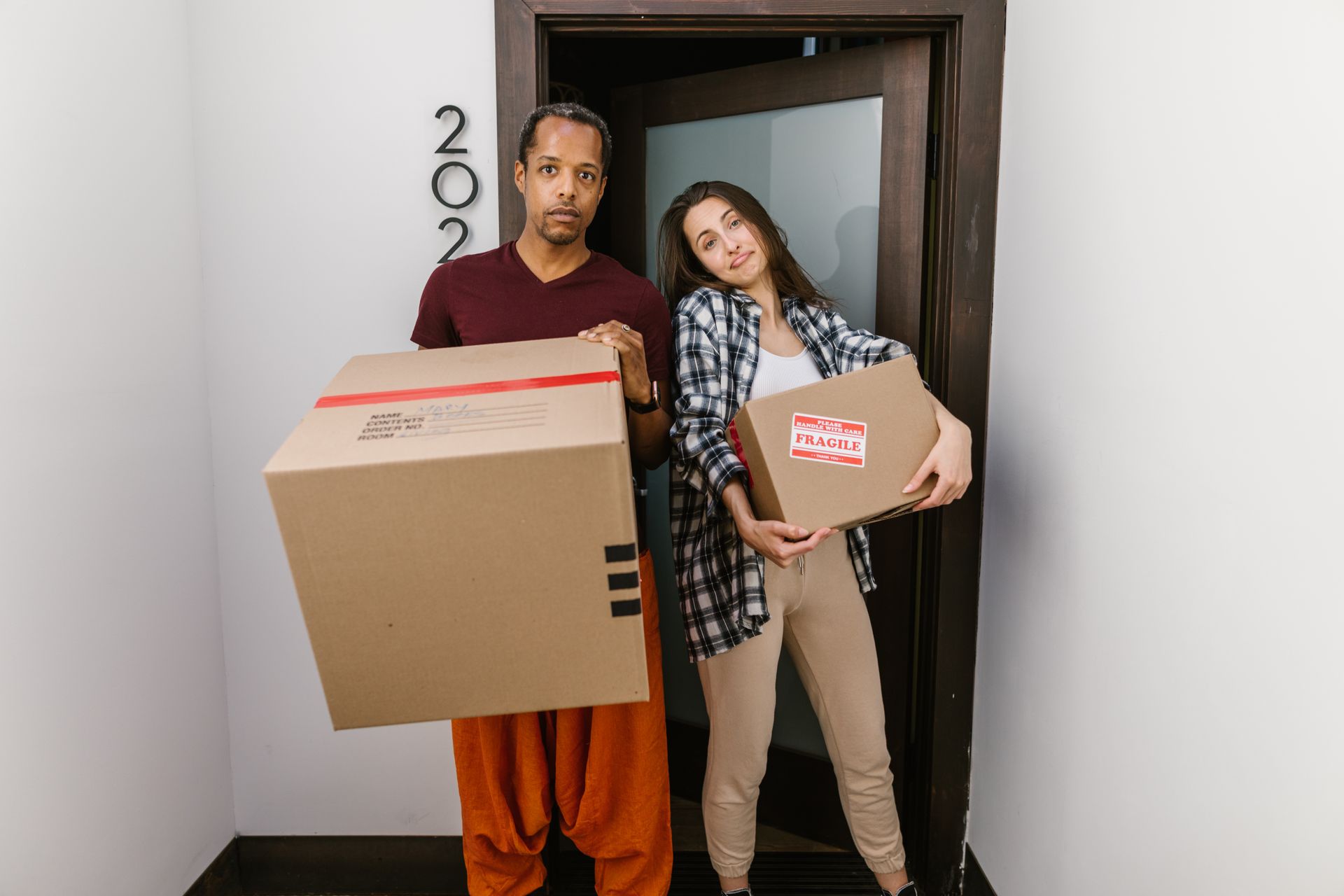 Movers carrying boxes into a home